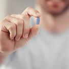 man holding blue medicine