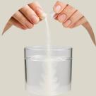 pouring medicine into water